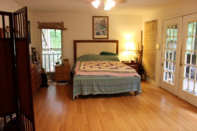 85 Woods Road Juliette, GA 31046 - Photo 14 of 36 a bedroom with a bed and wooden floor