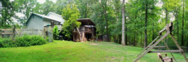 85 Woods Road Juliette, GA 31046 - Photo 34 of 36 a backyard of a house with plants and wooden fence