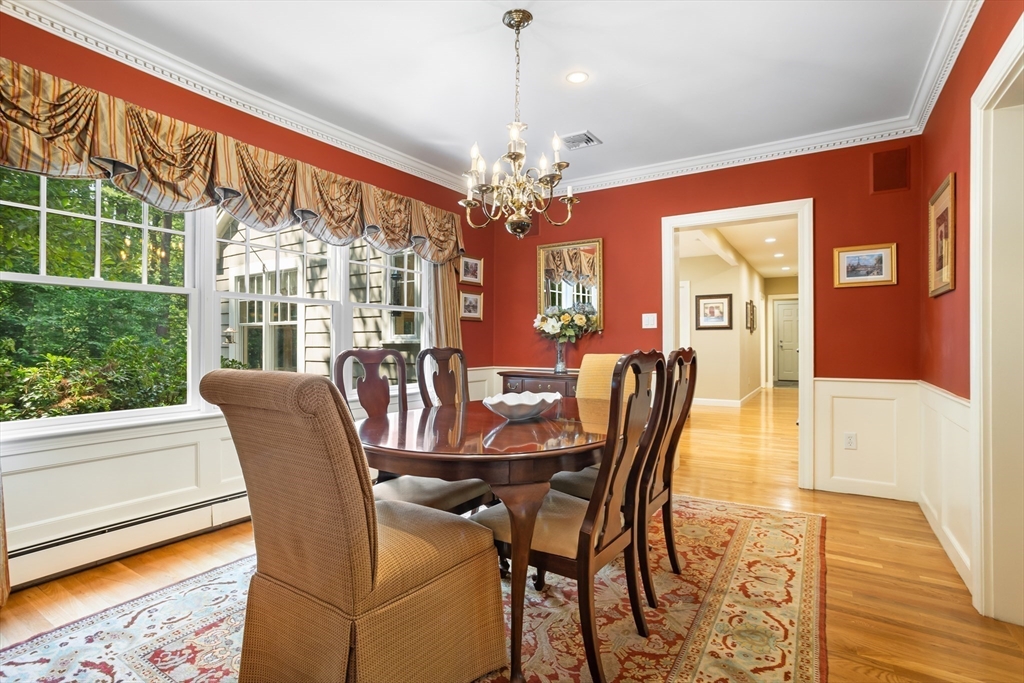 21 Grasshopper Lane Acton, MA 01720 - Photo 13 of 38 a view of a dining room with furniture wooden floor and chandelier