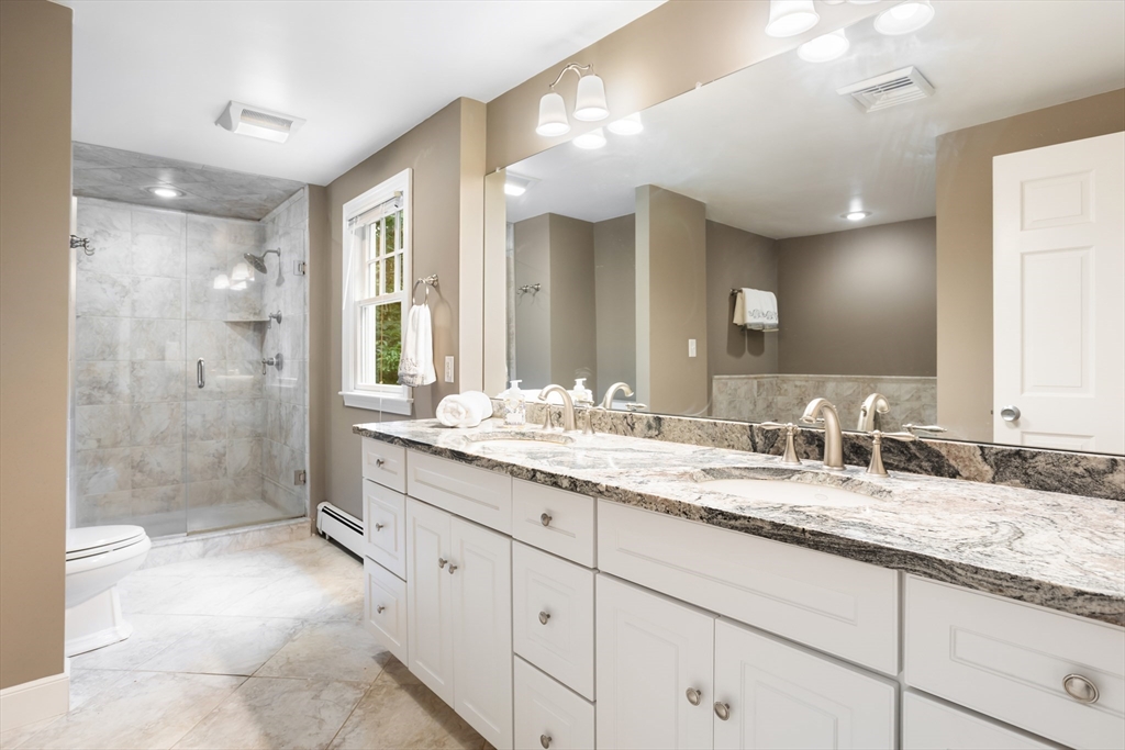21 Grasshopper Lane Acton, MA 01720 - Photo 21 of 38 a bathroom with a granite countertop sink mirror and double