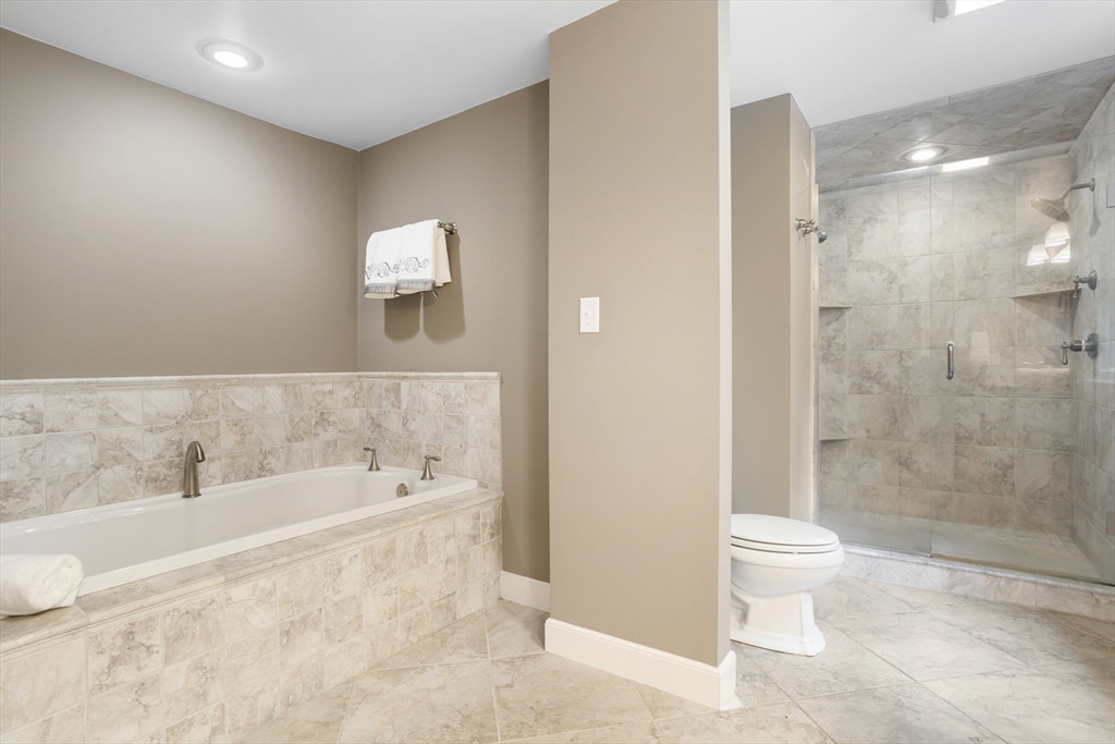 21 Grasshopper Lane Acton, MA 01720 - Photo 22 of 38 a bathroom with a bathtub and a toilet