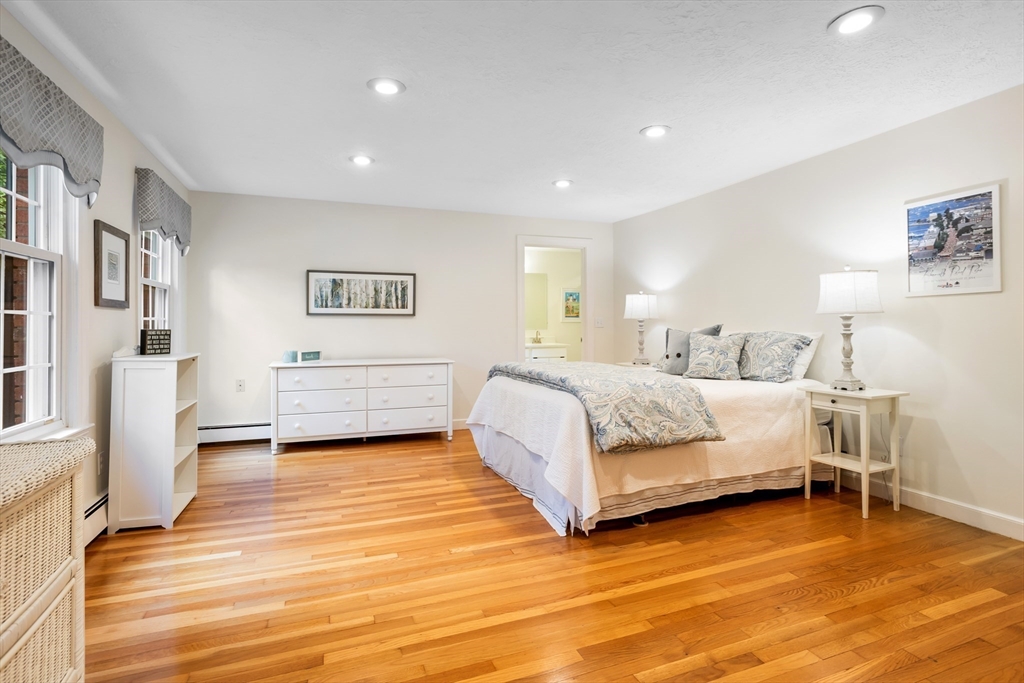 21 Grasshopper Lane Acton, MA 01720 - Photo 23 of 38 a bedroom with a bed and a view of kitchen