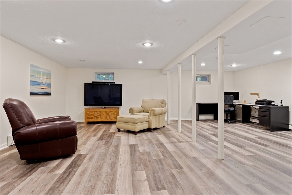 21 Grasshopper Lane Acton, MA 01720 - Photo 29 of 38 a living room with furniture and a flat screen tv