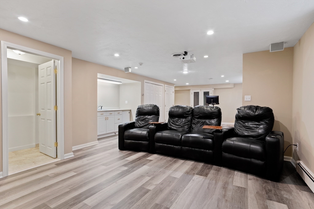 21 Grasshopper Lane Acton, MA 01720 - Photo 31 of 38 a living room with furniture and a wooden floor