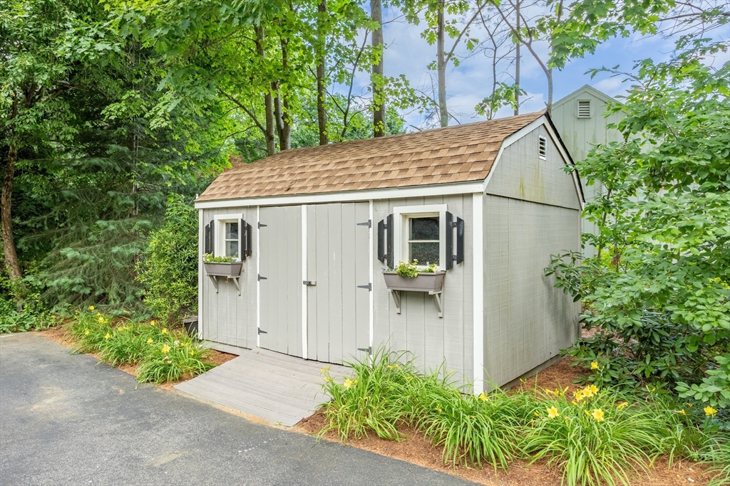 21 Grasshopper Lane Acton, MA 01720 - Photo 33 of 38 a view of a house with a tree and plants
