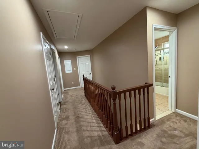 a view of a hallway with wooden floor and entryway