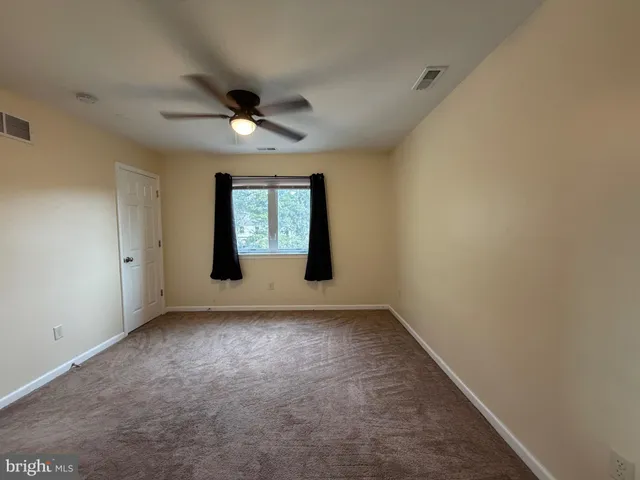 an empty room with a empty space and windows