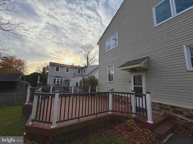 a view of a house with wooden fence