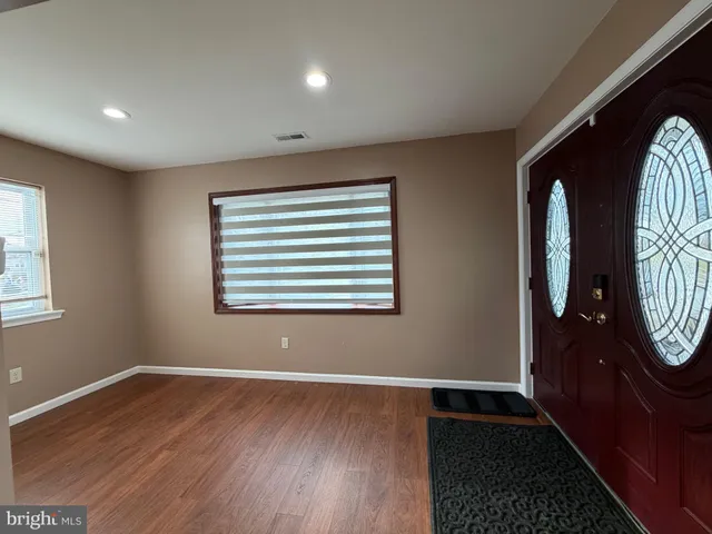 a view of an entryway with wooden floor