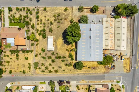 an aerial view of a residential apartment building with a yard