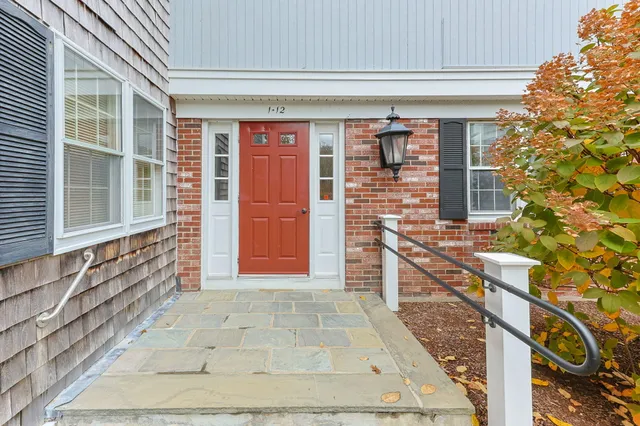 a view of front door of house with stairs