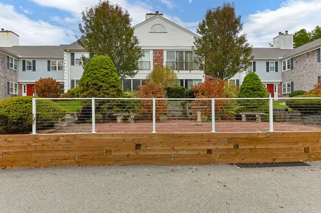front view of house with large windows and a table