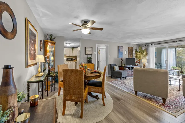 a living room with furniture a dining table and a window
