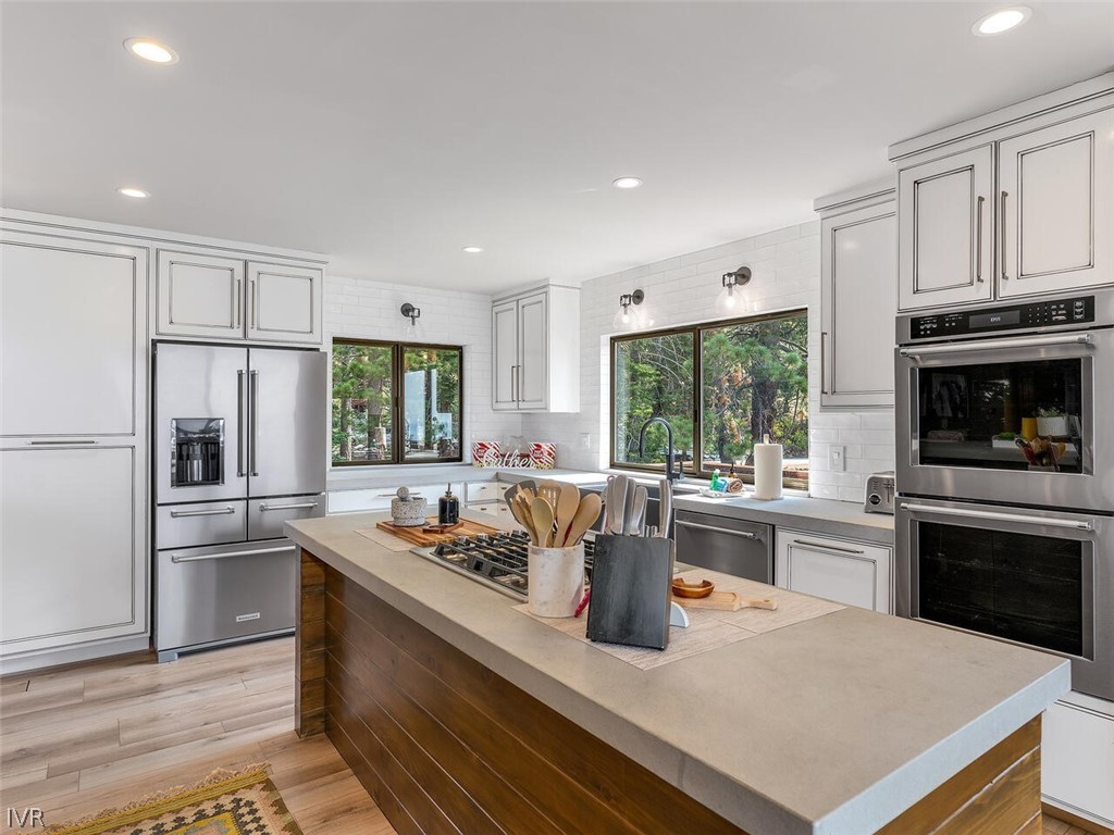 751 Champagne Road Incline Village, NV 89451 - Photo 12 of 30 a kitchen with a stove a refrigerator and a sink