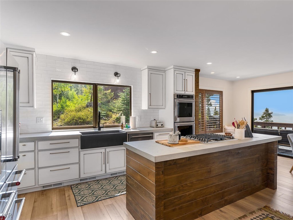 751 Champagne Road Incline Village, NV 89451 - Photo 13 of 30 a bathroom with a sink and a large mirror