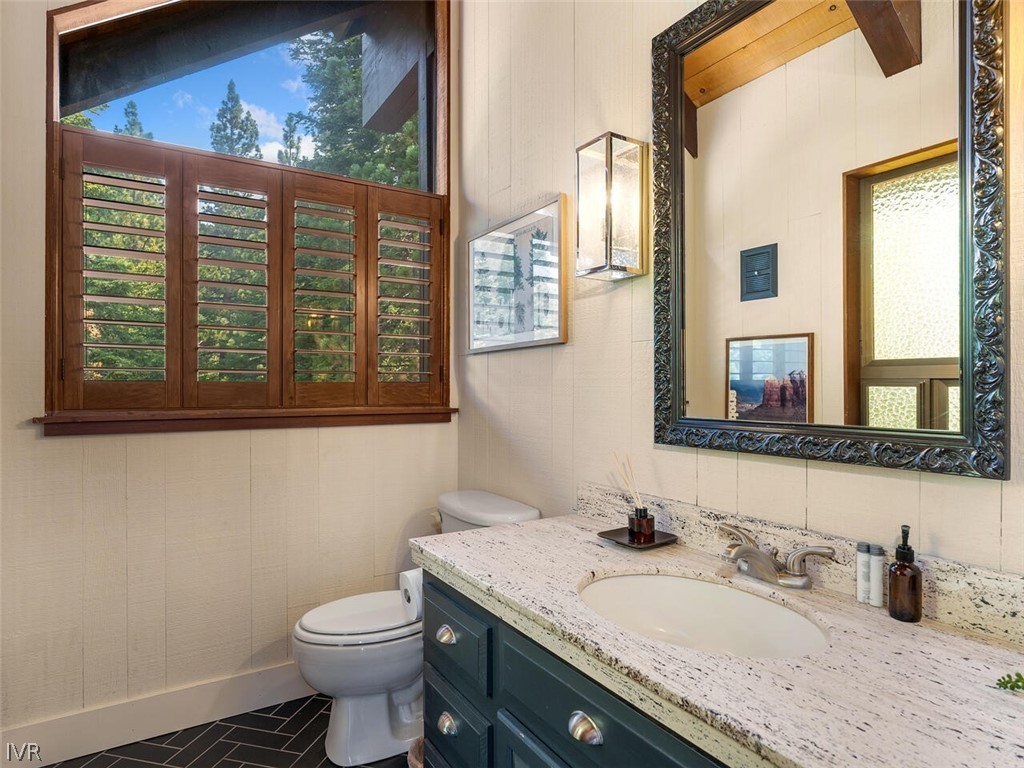 751 Champagne Road Incline Village, NV 89451 - Photo 15 of 30 a bathroom with a granite countertop sink and a toilet