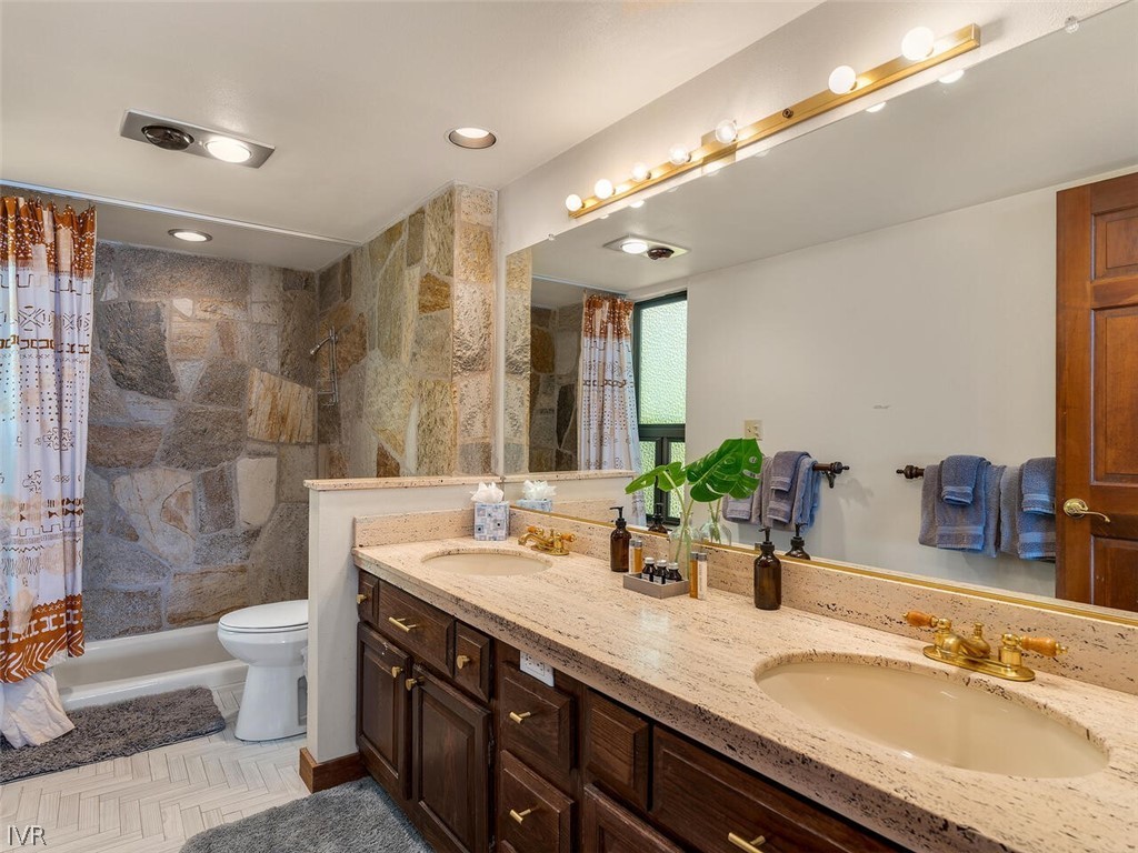 751 Champagne Road Incline Village, NV 89451 - Photo 21 of 30 a bathroom with a granite countertop double vanity sink mirror double shower and a bathtub