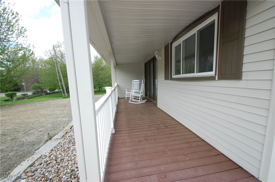 Wooden terrace featuring a porch
