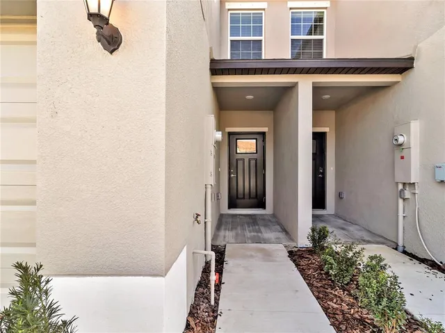 a view of a terrace with lawn chairs