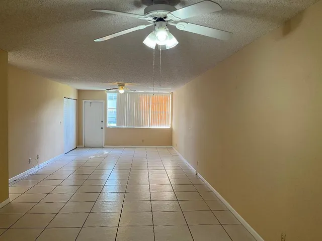 a tall tree in middle of green field