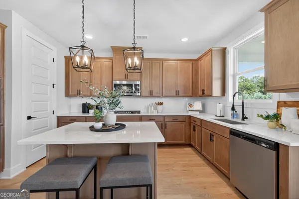 a kitchen with sink cabinets and dining table