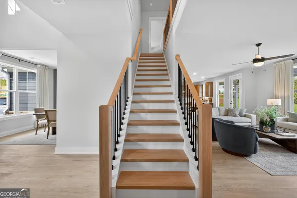 a view of a hallway with wooden floor and windows