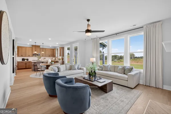 a living room with furniture and a large window