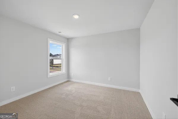 a view of staircase with wooden floor and white walls