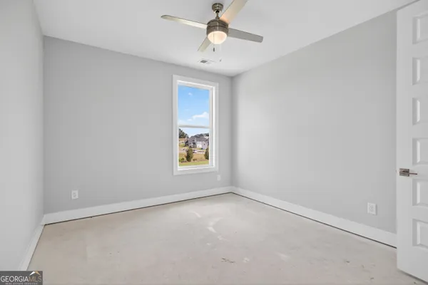 a view of a hallway with windows and stairs