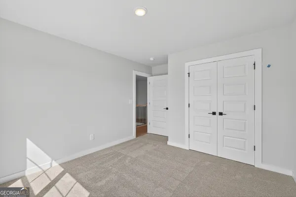a spacious bedroom with a bed and furniture