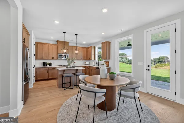 a kitchen with a table and chairs in it