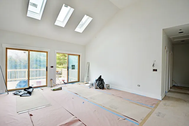 a bed room with a bed and a large window