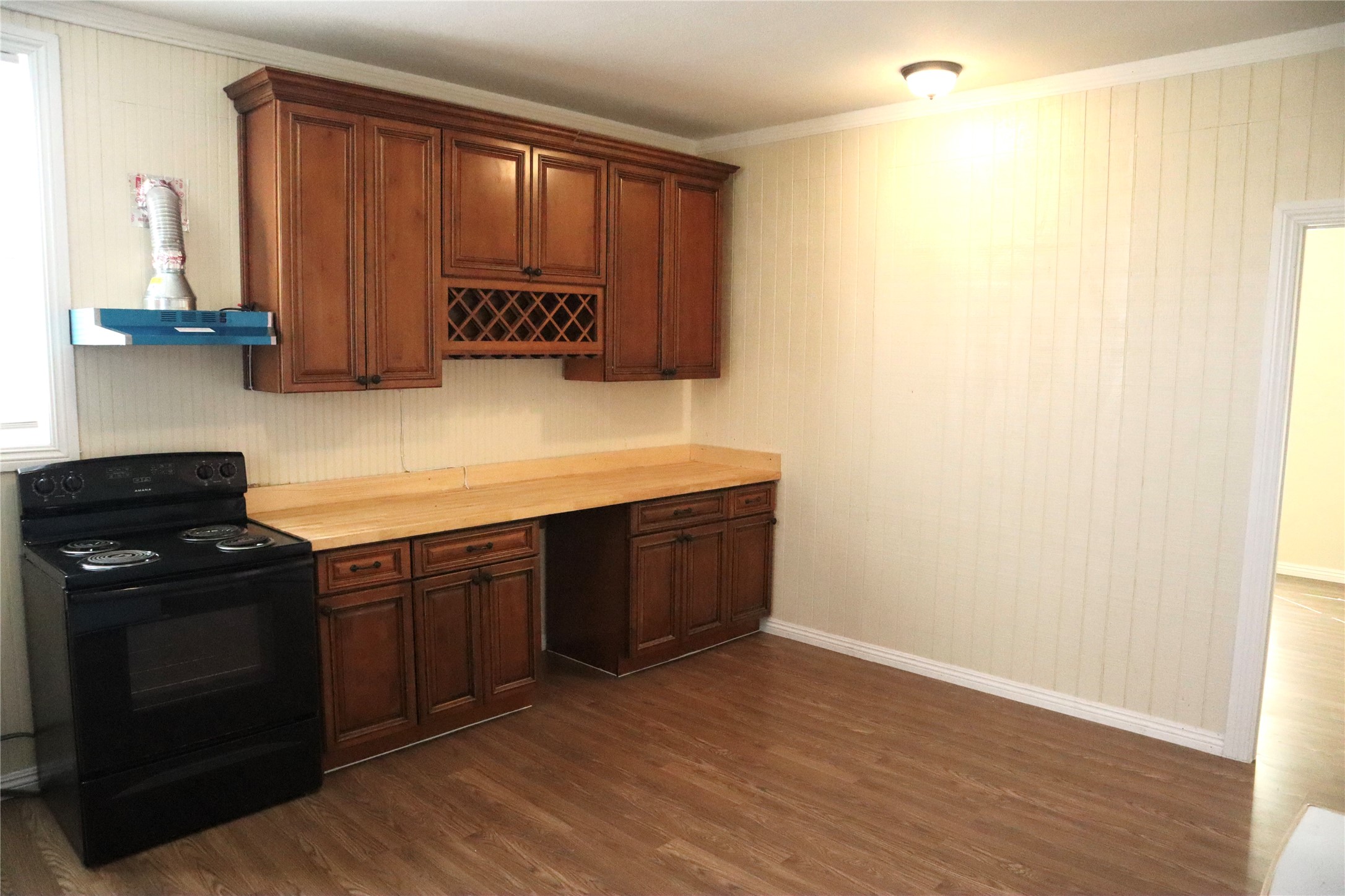 2689 County Road 32 Angleton, TX 77515 - Photo 11 of 15 a kitchen with a stove and a wooden cabinets