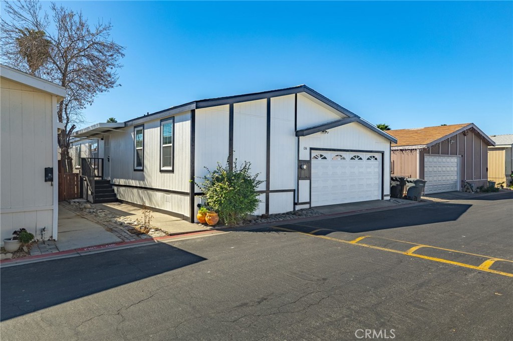 80 East Dawes Street, Unit 126 Perris, CA 92571 - Photo 1 of 39 a front view of a house with garden