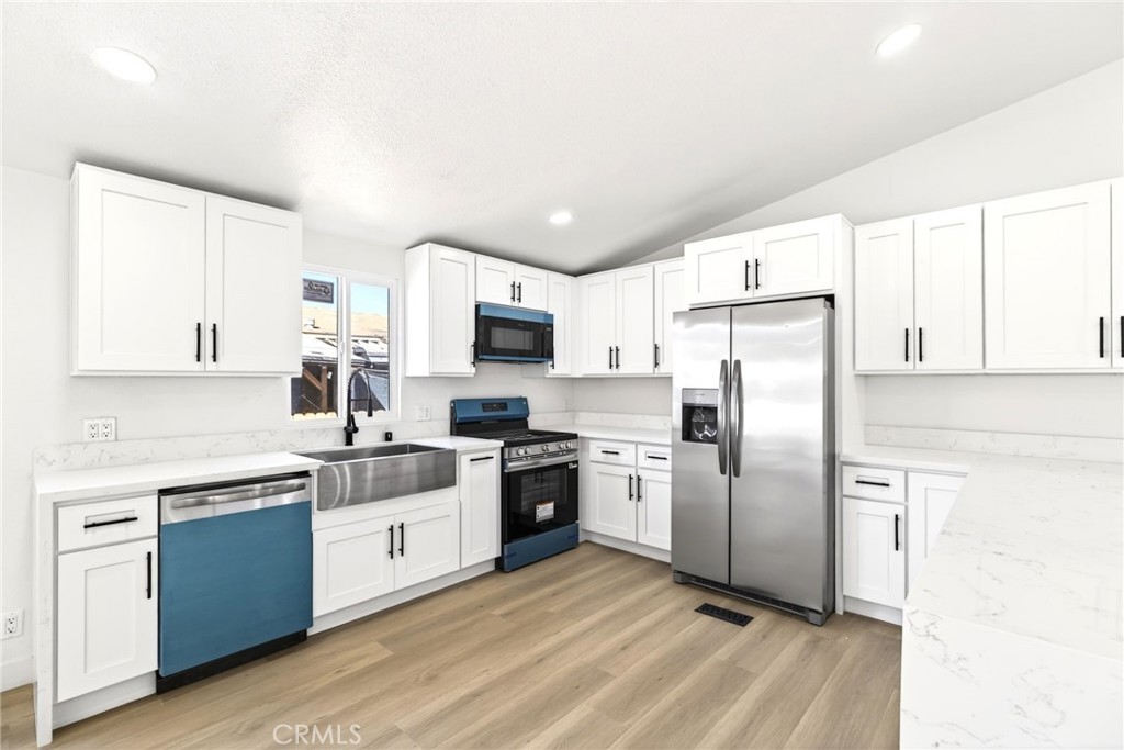 80 East Dawes Street, Unit 126 Perris, CA 92571 - Photo 11 of 39 a kitchen with stainless steel appliances a refrigerator sink and microwave