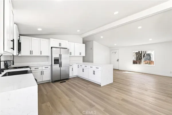 a kitchen with white cabinets and white appliances