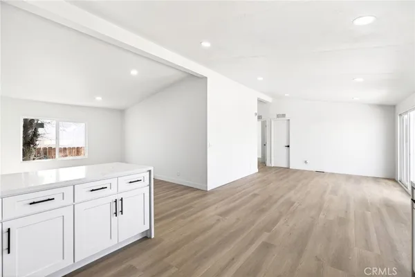 a view of a kitchen with white cabinets