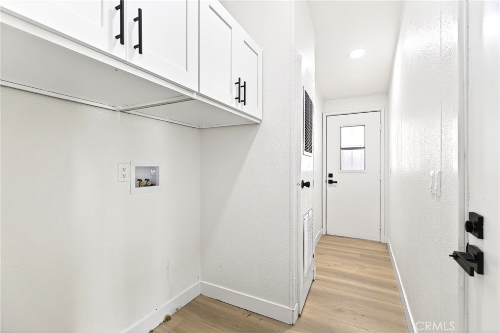 80 East Dawes Street, Unit 126 Perris, CA 92571 - Photo 16 of 39 a view of a hallway with wooden floor and a cabinet