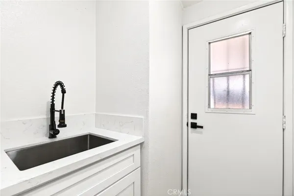 a close view of a sink and dishwasher with kitchen view