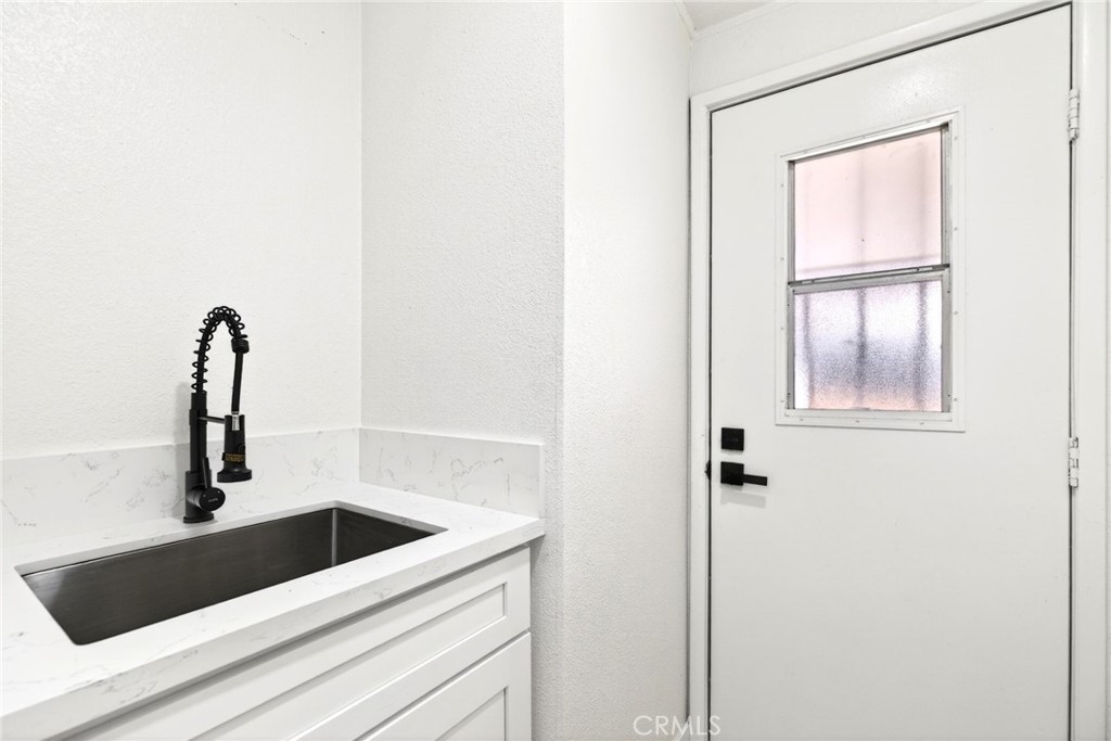 80 East Dawes Street, Unit 126 Perris, CA 92571 - Photo 17 of 39 a close view of a sink and dishwasher with kitchen view