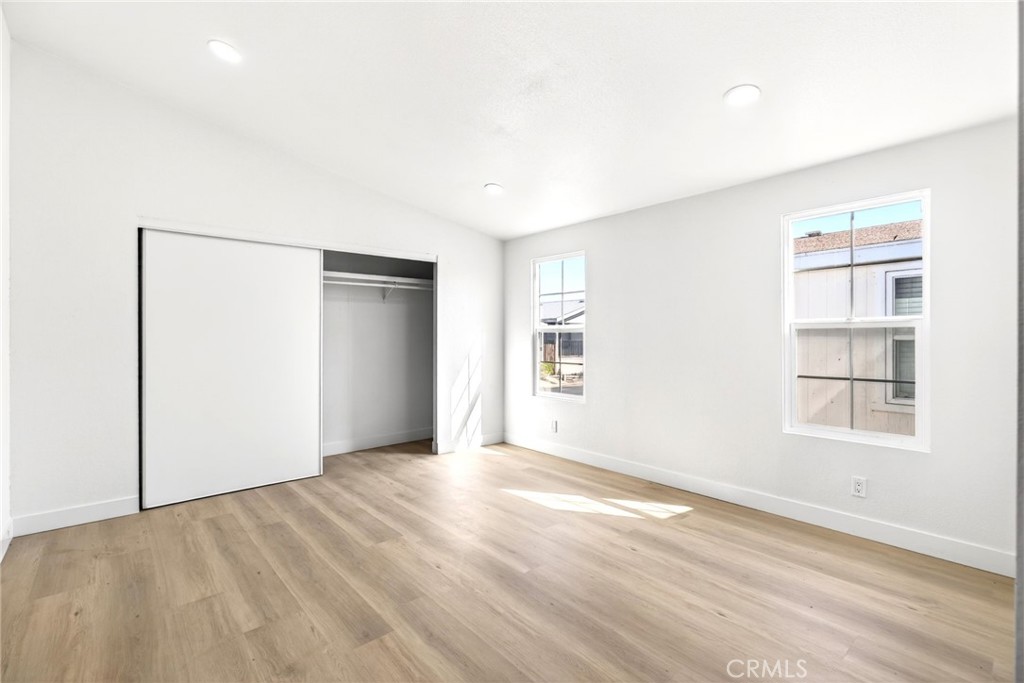 80 East Dawes Street, Unit 126 Perris, CA 92571 - Photo 18 of 39 a view of an empty room with wooden floor and a window