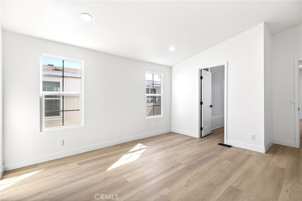 80 East Dawes Street, Unit 126 Perris, CA 92571 - Photo 19 of 39 an empty room with wooden floor and windows