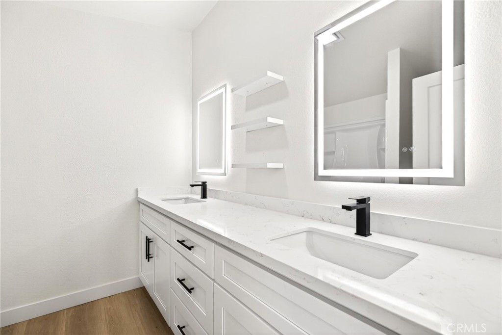 80 East Dawes Street, Unit 126 Perris, CA 92571 - Photo 21 of 39 a bathroom with a sink and a mirror