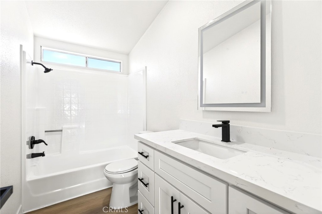 80 East Dawes Street, Unit 126 Perris, CA 92571 - Photo 24 of 39 a bathroom with a sink a toilet and a mirror