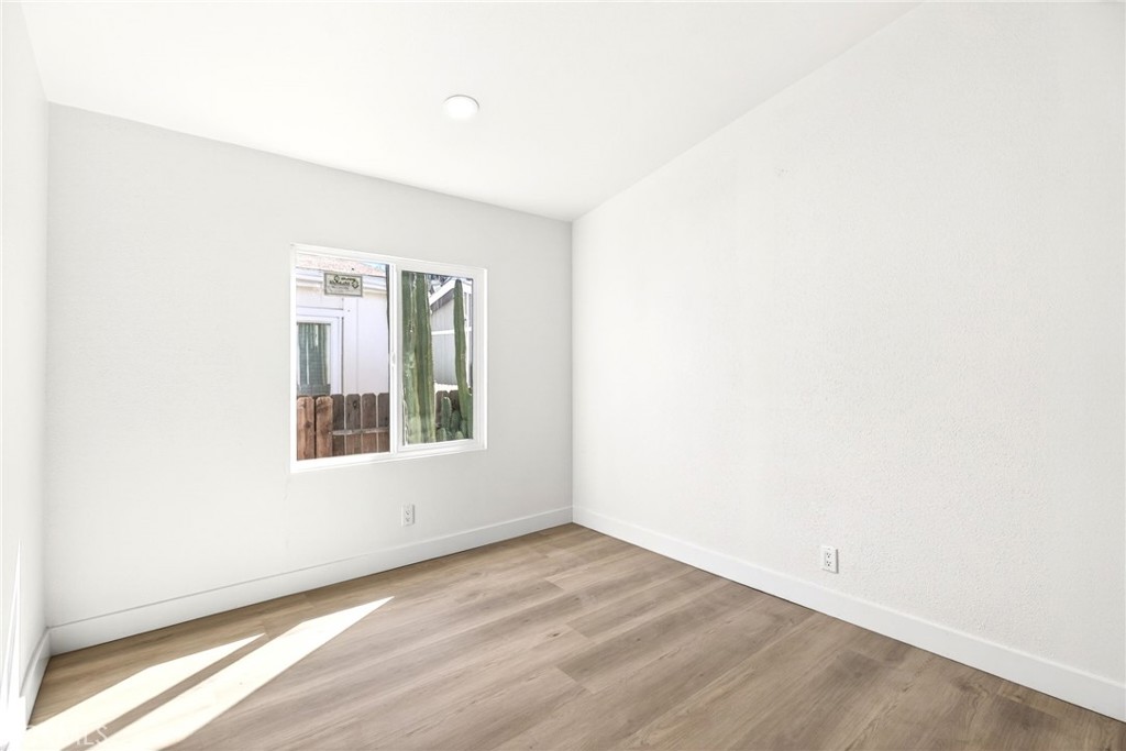 80 East Dawes Street, Unit 126 Perris, CA 92571 - Photo 25 of 39 an empty room with wooden floor and windows