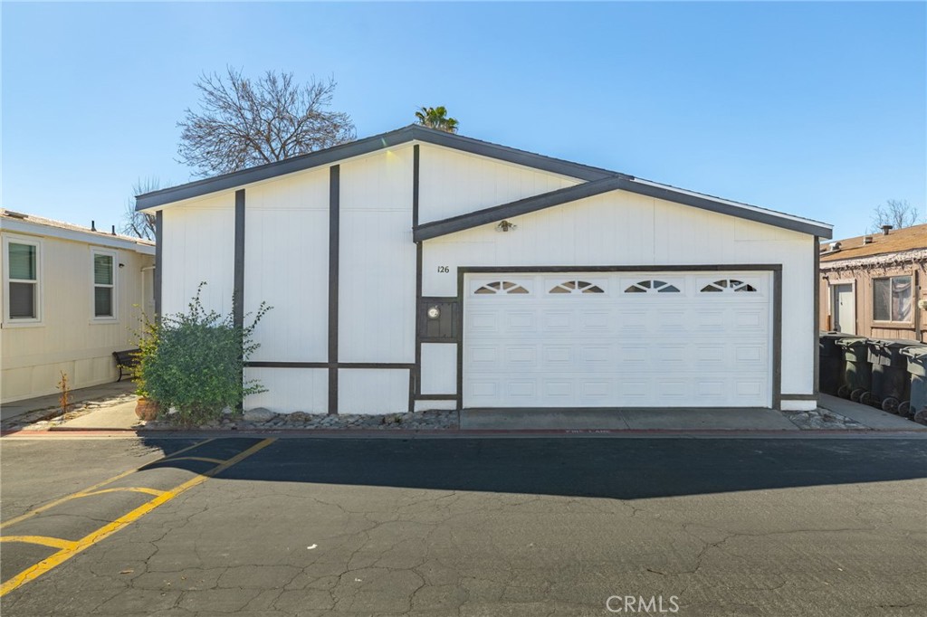 80 East Dawes Street, Unit 126 Perris, CA 92571 - Photo 3 of 39 a front view of a house with garage