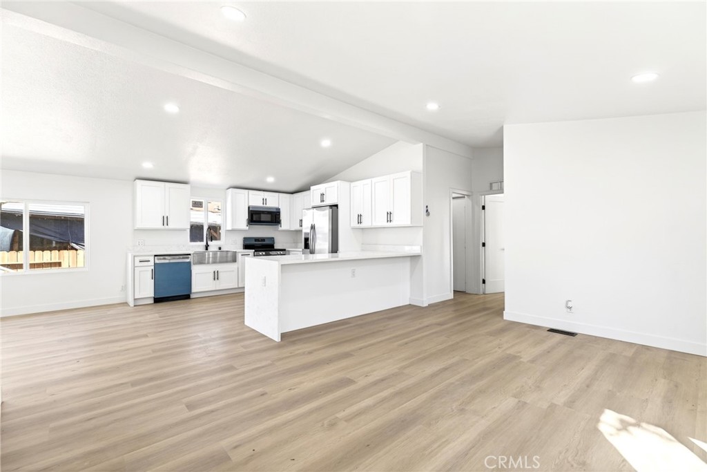 80 East Dawes Street, Unit 126 Perris, CA 92571 - Photo 5 of 39 a view of kitchen with wooden floor and electronic appliances