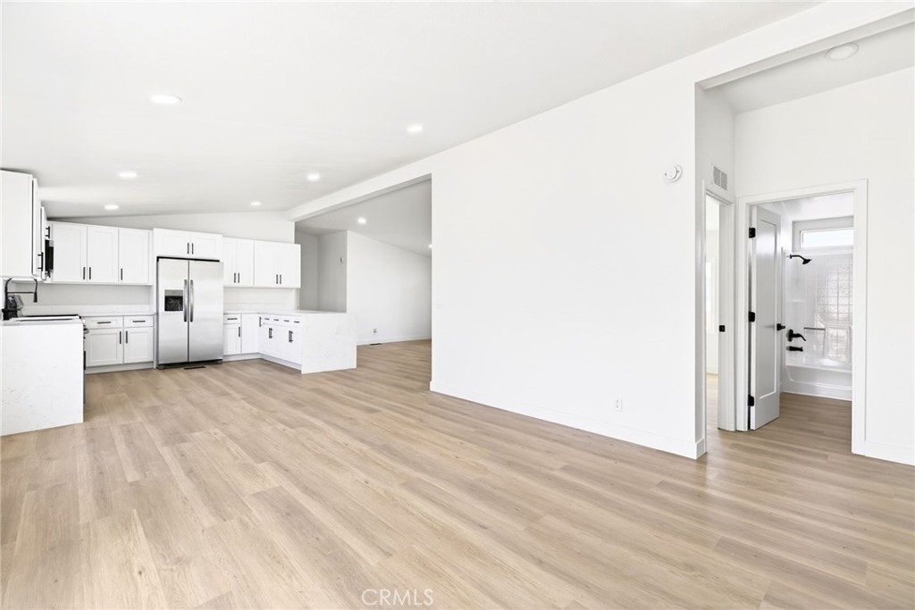 80 East Dawes Street, Unit 126 Perris, CA 92571 - Photo 9 of 39 a view of a kitchen with wooden floor and a refrigerator