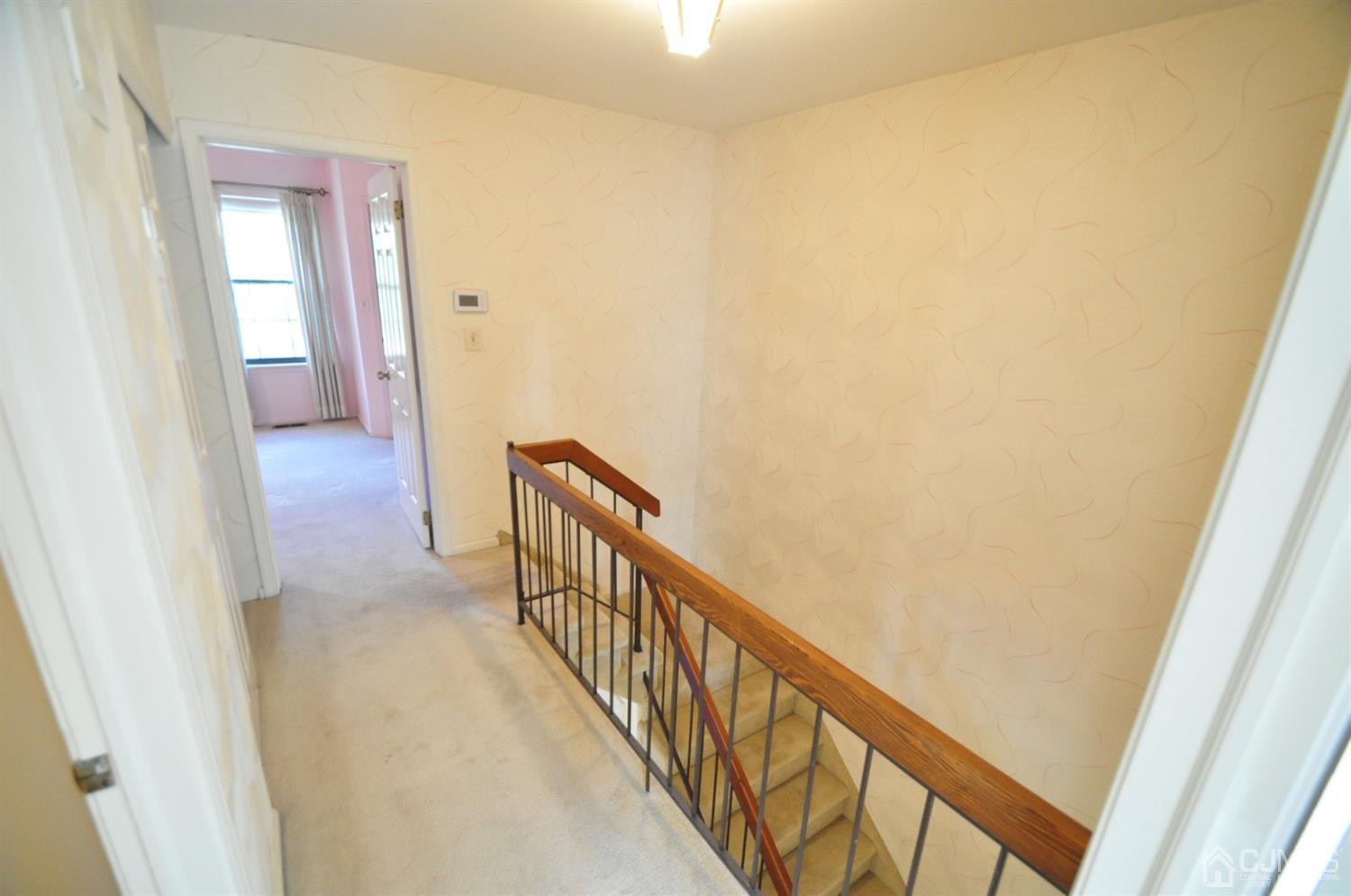 502 Timber Oaks Road Edison, NJ 08820 - Photo 17 of 21 a view of a hallway with wooden floor