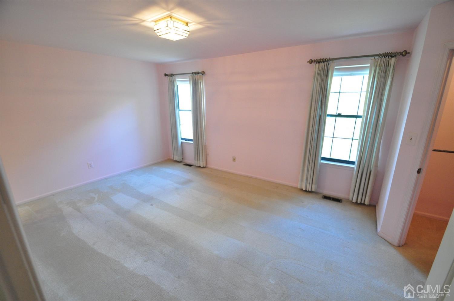 502 Timber Oaks Road Edison, NJ 08820 - Photo 5 of 21 an empty room with windows and hardwood floor
